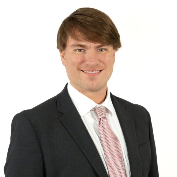 A Man Wearing A Suit And Tie